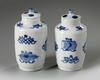 A pair of small Chinese blue and white vases and covers
