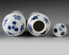 A pair of small Chinese blue and white vases and covers