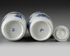 A pair of small Chinese blue and white vases and covers