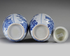 A pair of Chinese blue and white 'floral' vases and covers