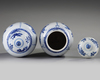 A pair of Chinese blue and white 'floral' vases and covers