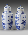 A pair of Chinese blue and white 'floral' vases and covers