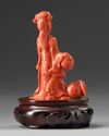 A small Chinese red coral carving of a lady and boy