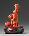 A small Chinese red coral carving of a lady and boy