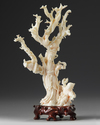 A Chinese pale coral carving of a lady and a boy