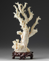 A Chinese pale coral carving of a lady and a boy