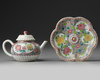 A CHINESE PINK-GROUND FAMILLE ROSE MOULDED 'CHRYSANTHEMUM' TEAPOT, COVER AND STAND