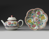 A CHINESE PINK-GROUND FAMILLE ROSE MOULDED 'CHRYSANTHEMUM' TEAPOT, COVER AND STAND
