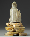 A Chinese soapstone Guanyin figure on stand