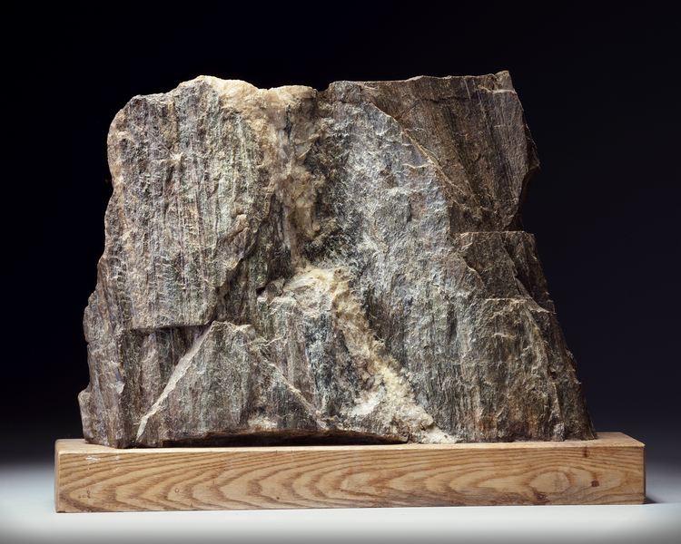 A Japanese Suiseki (Aesthetic) natural stone on a wooden base