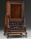 A Chinese gilt bronze table clock in a hongmu case and stand