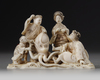 A Japanese ivory okimono of a group of four on the beach