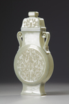 A Chinese celadon jade flattened vase and cover