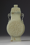 A Chinese celadon jade flattened vase and cover