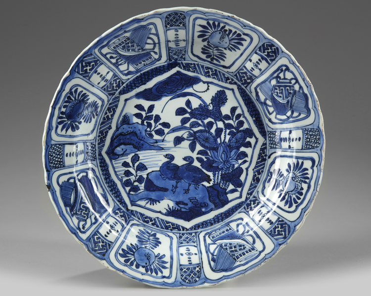 A CHINESE BLUE AND WHITE 'DUCKS AND LOTUS 'KRAAK PORCELEIN' DISH, WANLI PERIOD (1573-1619)