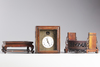 A Chinese gilt bronze table clock in a hongmu case and stand
