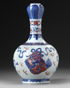 A Chinese copper-red-decorated blue and white garlic-head vase