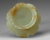 A CHINESE PALE AND RUSSET CARVED JADE 'LOTUS' CENSER