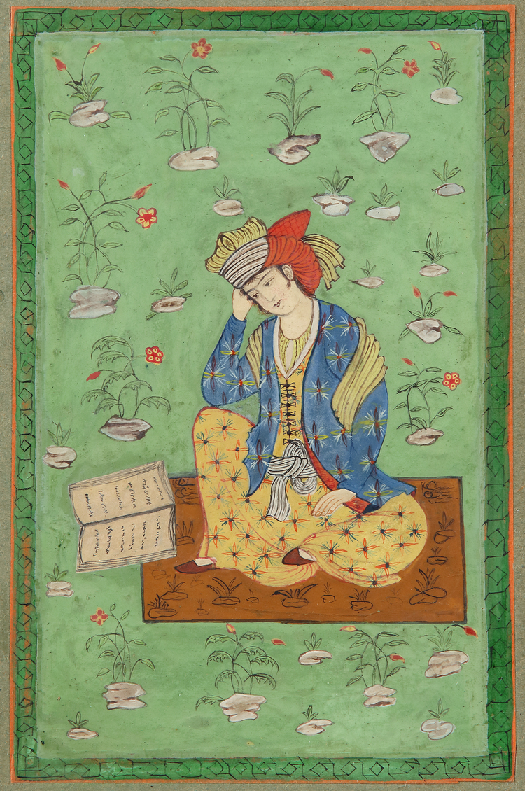 A seated young man with a book
