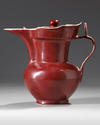 A CHINESE RUBY-RED GLAZED MONK'S CAP EWER