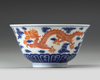 A CHINESE BLUE AND WHITE IRON-RED DECORATED 'DRAGON' BOWL, SIX-CHARACTER JIAQING MARK AND OF THE PERIOD (1796-1820)