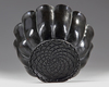 A MUGHAL BLACK GLAZED LOTUS SHAPED CERAMIC BOWL