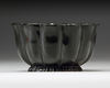 A MUGHAL BLACK GLAZED LOTUS SHAPED CERAMIC BOWL