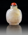 A CHINESE SHADOW AGATE 'BUDDHIST LION' SNUFF BOTTLE