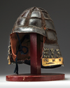 A JAPANESE WARRIOR HELMET (KABUTO) CONSISTING OF BLACK LACQUERED METAL PLATES