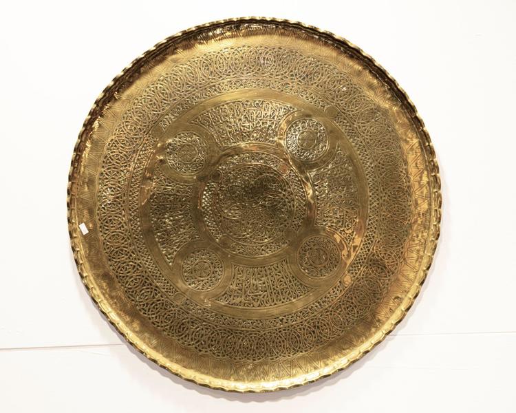 A BRASS CIRCULAR CARVED TRAY, SYRIA OR EGYPT, 19TH CENTURY