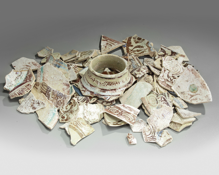A LARGE GROUP OF RAQQA LUSTREWARE FRAGMENTS AND VASE NECK, SYRIA, 12TH CENTURY