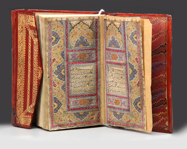 A SMALL RED LEATHER-BOUND QURAN