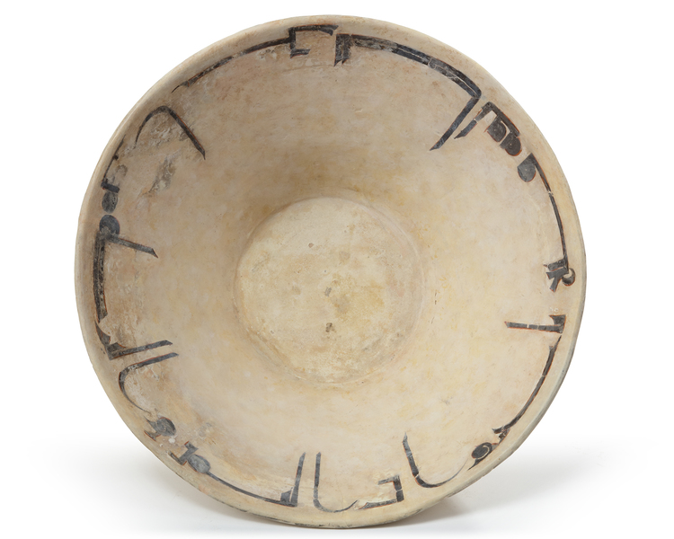 A NISHAPUR CALLIGRAPHIC SLIP-PAINTED POTTERY BOWL, PERSIA, 10TH CENTURY