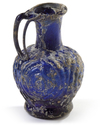 A SMALL BLUE MOULDED GLASS EWER, SYRIA, 10TH CENTURY