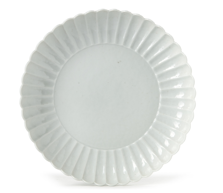 A CHINESE CARVED WHITE GLAZED 'LOTUS' DISH
