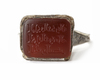 AN ISLAMIC NIELLOED  SILVER RING SET WITH AN INSCRIBED CORNELIAN IN A SQUARE BEZEL, MOSUL AREA, 8TH-9TH CENTURY