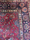 A LARGE SIGNED MESHED CARPET, NORTH-EAST PERSIA