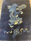 A CHINESE FOO DOG PEKING RUG, 1920
