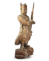A CHINESE PAINTED AND LACQUERED WOOD FIGURE OF A GUARDIAN, LATE MING DYNASTY (1368-1644)