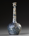 A TALL-NECKED BLUE GLASS BOTTLE, PERSIA OR SYRIA, 11TH-12TH CENTURY