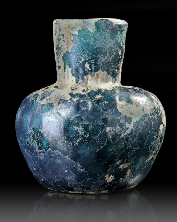A MOULDED BLUE GLASS BOTTLE, NISHAPUR, NORTH-EAST IRAN, 9TH CENTURY
