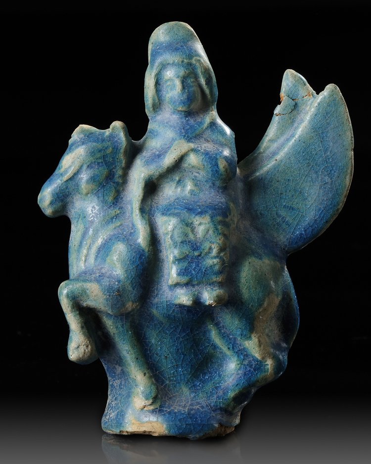 A SEATED FIGURINE ON A FLYING ANIMAL, 12TH-13TH CENTURY