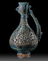 A RARE FRITWARE OPENWORK DECORATED RETICULATED EWER WITH ROOSTER HEAD, PERSIA, 13TH CENTURY