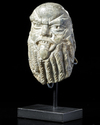 A SMALL STONE CARVED HEAD OF BES