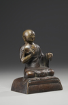 A bronze figure of a Lama