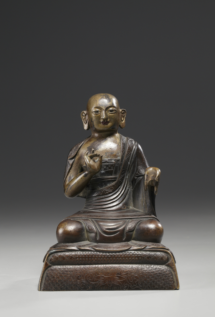 A bronze figure of a Lama