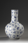 A large blue and white butterfly vase
