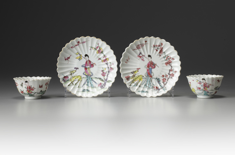 A pair of famille rose moulded cups and saucers