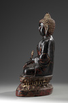 A Large Bronze Buddha Sitting on a Lotus