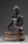 A Large Bronze Buddha Sitting on a Lotus